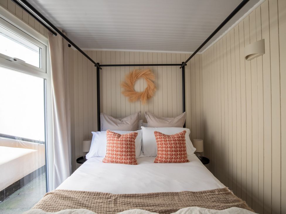 A bedroom with a bed and pillows at Rainbow Cottage in Aughton near Ormskirk