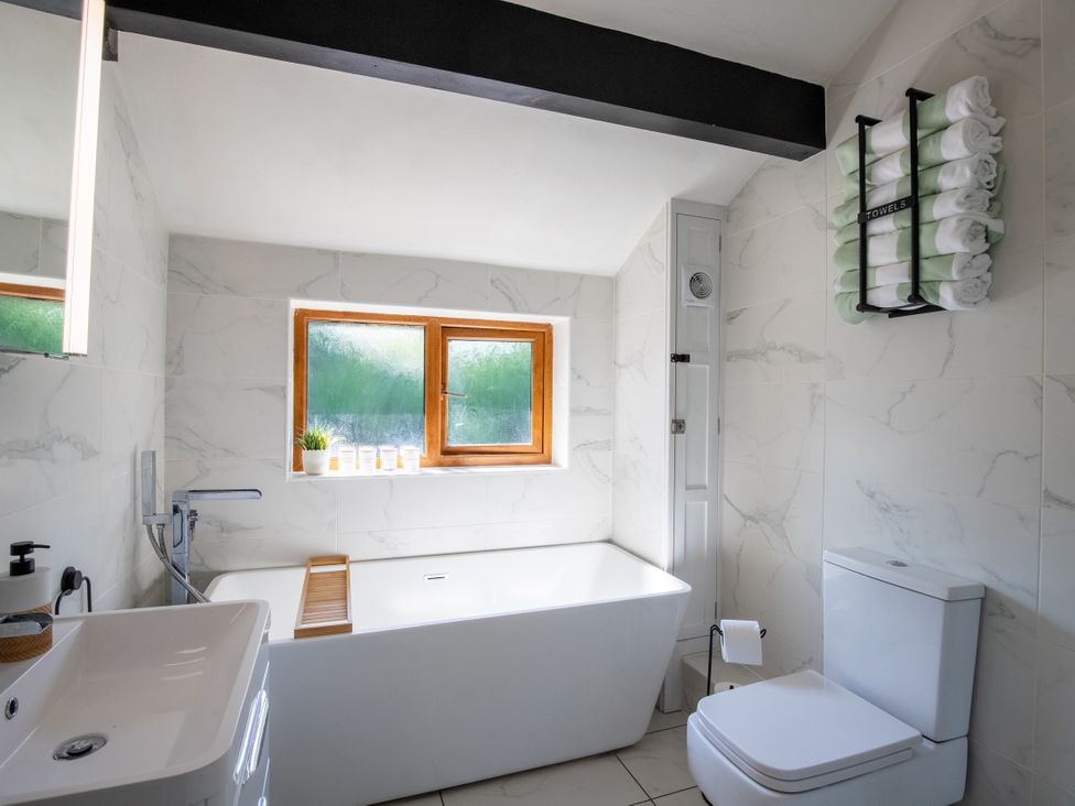 A bathroom with bathtub and sink at Rainbow Cottage in Aughton near Ormskirk