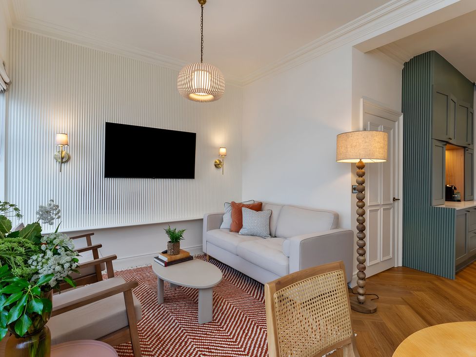 A living room with a television and sofa at Seafront Apartment in Donaghadee