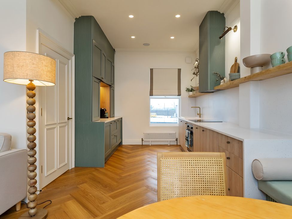 A kitchen with a sink and stove at Seafront Apartment in Donaghadee