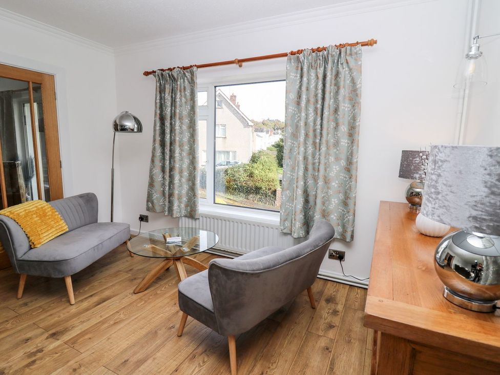 A living room with two armchairs and a coffee table at Tymelyn in Aberystwyth
