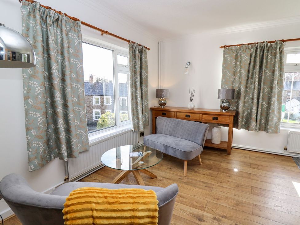 A living room with a sofa and coffee table at Tymelyn in Aberystwyth