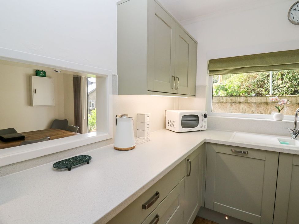 A kitchen with a sink and microwave at Tymelyn in Aberystwyth