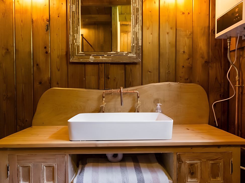 A sink and faucet with a mirror at Badger - Luxury Glamping Retreat, Battle