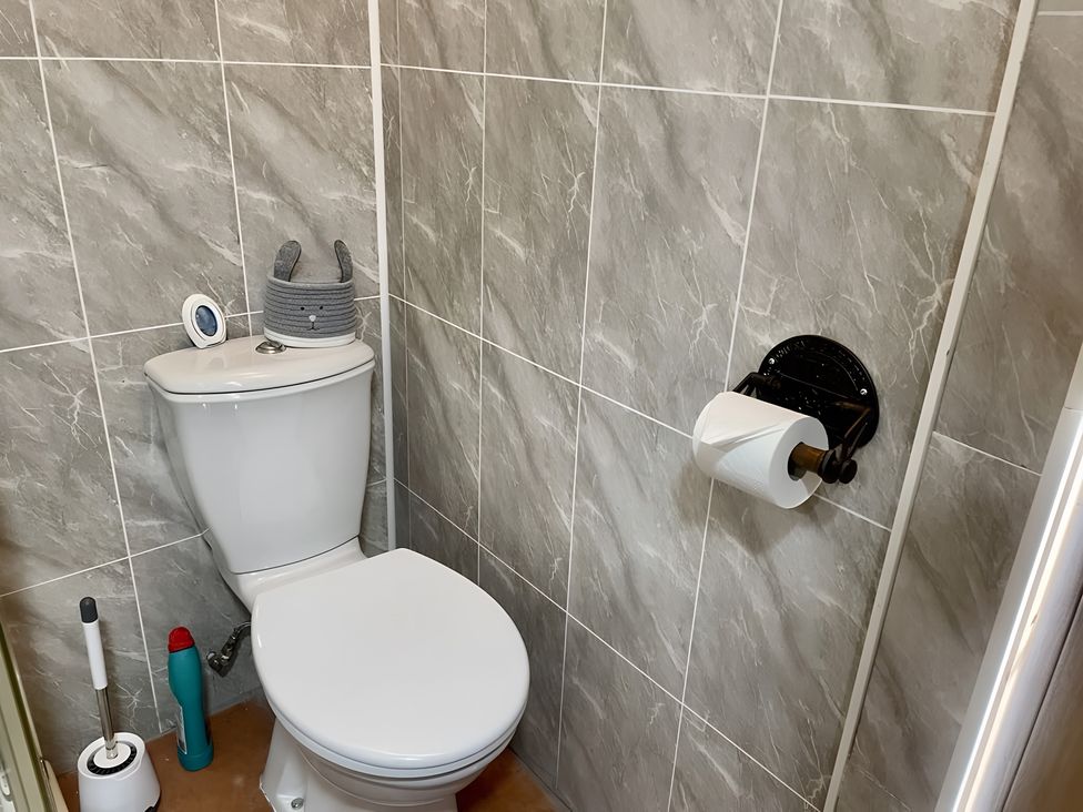 A bathroom with a toilet and decorative items at Tylands in Camelford
