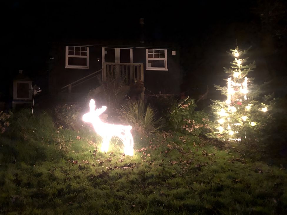 A deer decoration and a Christmas tree in front of a house at Tylands in Camelford