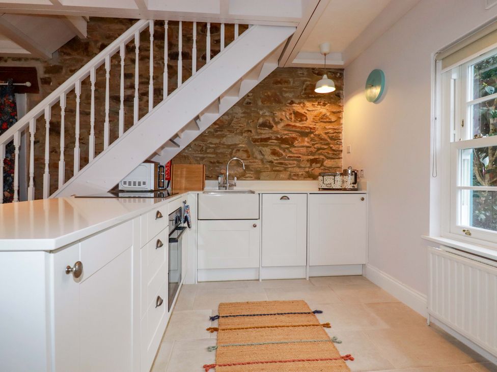 A kitchen with cabinets and a sink at Cubbs Corner in Goonbell near St Agnes