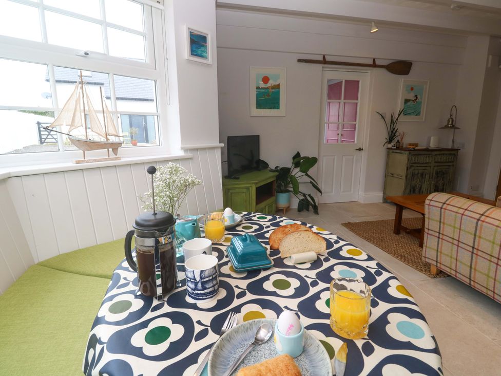A dining room with a table set for breakfast at Cubs Corner in St Agnes