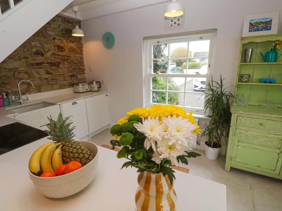 A kitchen with fruits and flowers on the counter at Cubs Corner in St Agnes