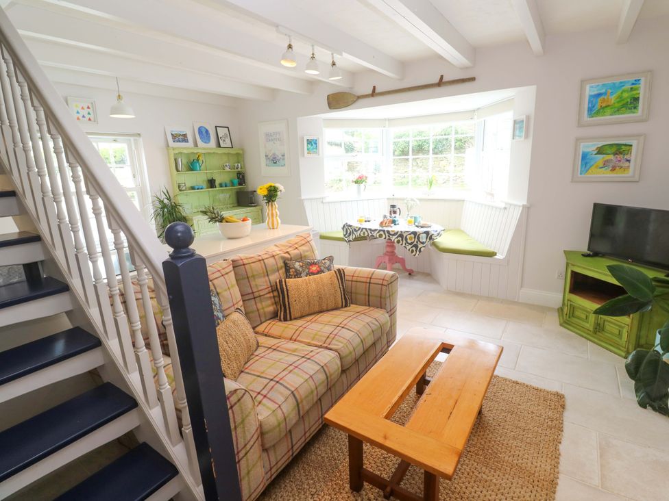 A living room with a sofa and coffee table at Cubs Corner in St Agnes