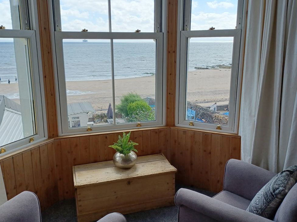 A seating area with a view of the sea at Beach Haven 116 Leven