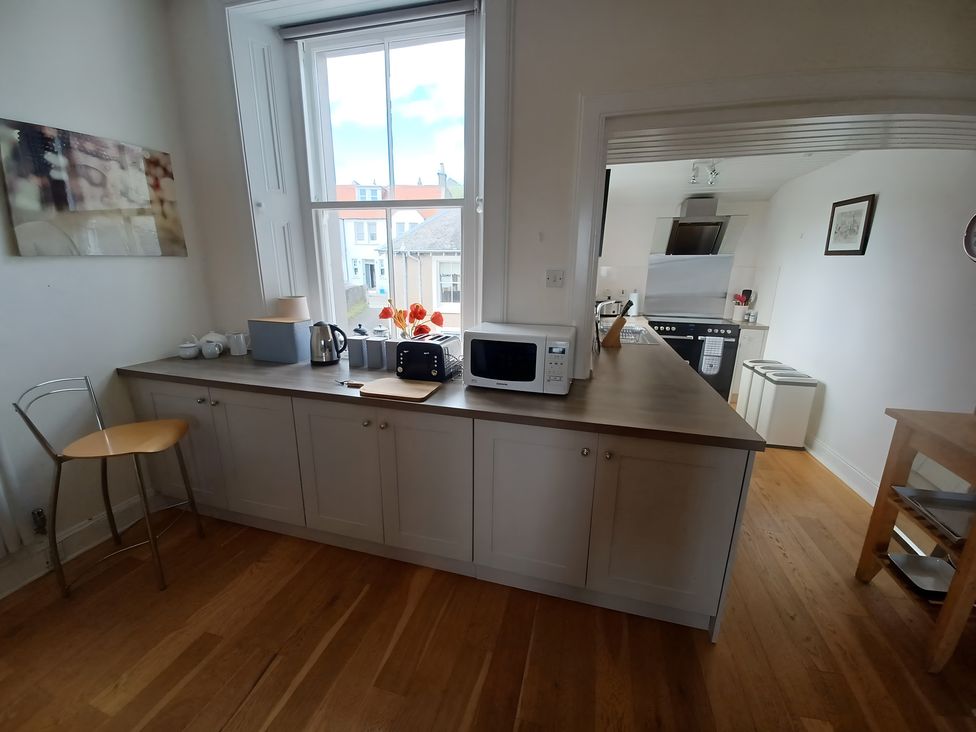 A kitchen with a kettle, microwave, and toaster at Beach Haven 116 in Leven