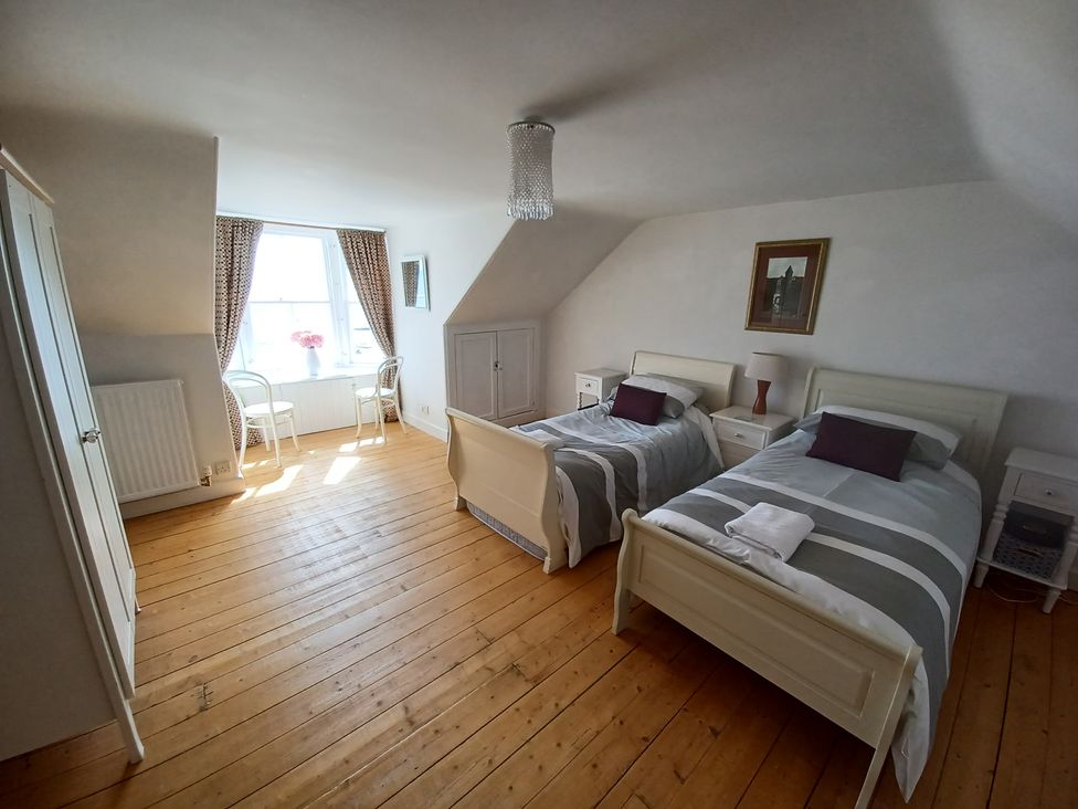 A bedroom with two beds and a window at Beach Haven 116 Leven