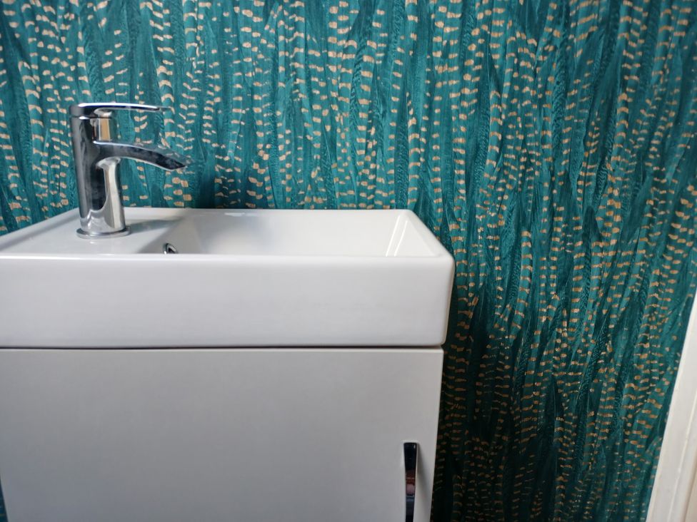 A sink with faucet in a bathroom at Beach Haven 116 Leven