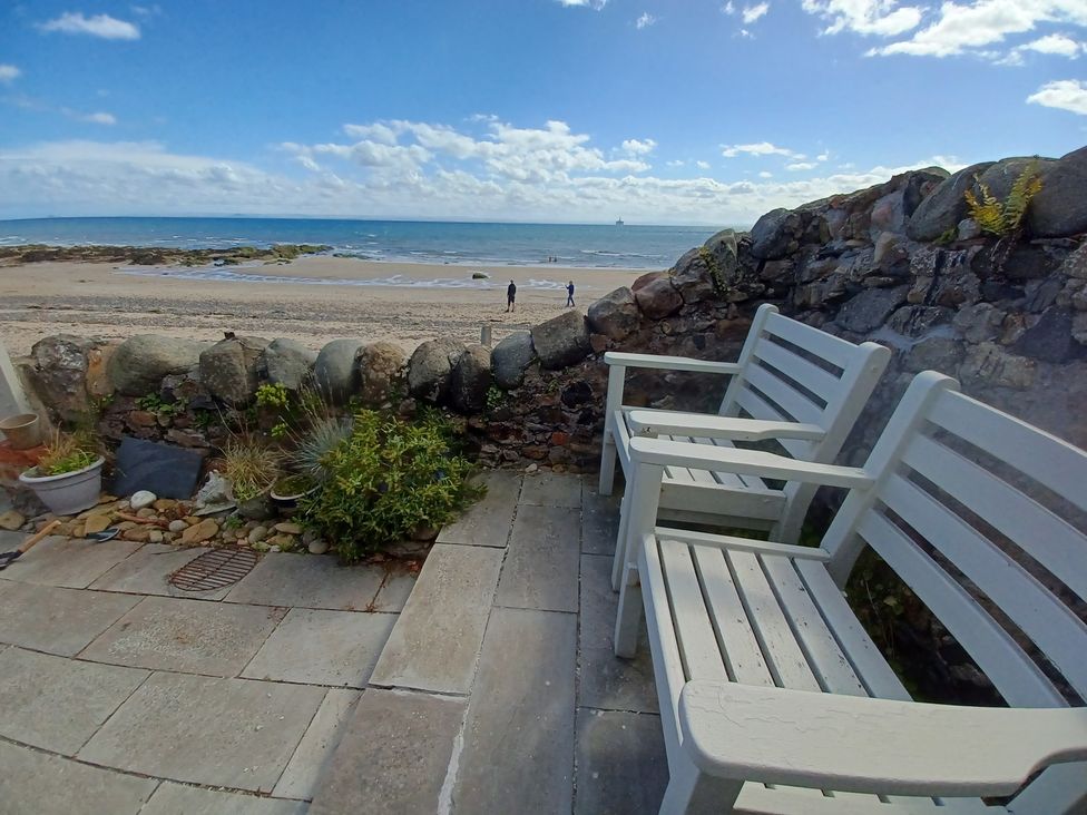 Two chairs facing the beach at Beach Haven 116 Leven