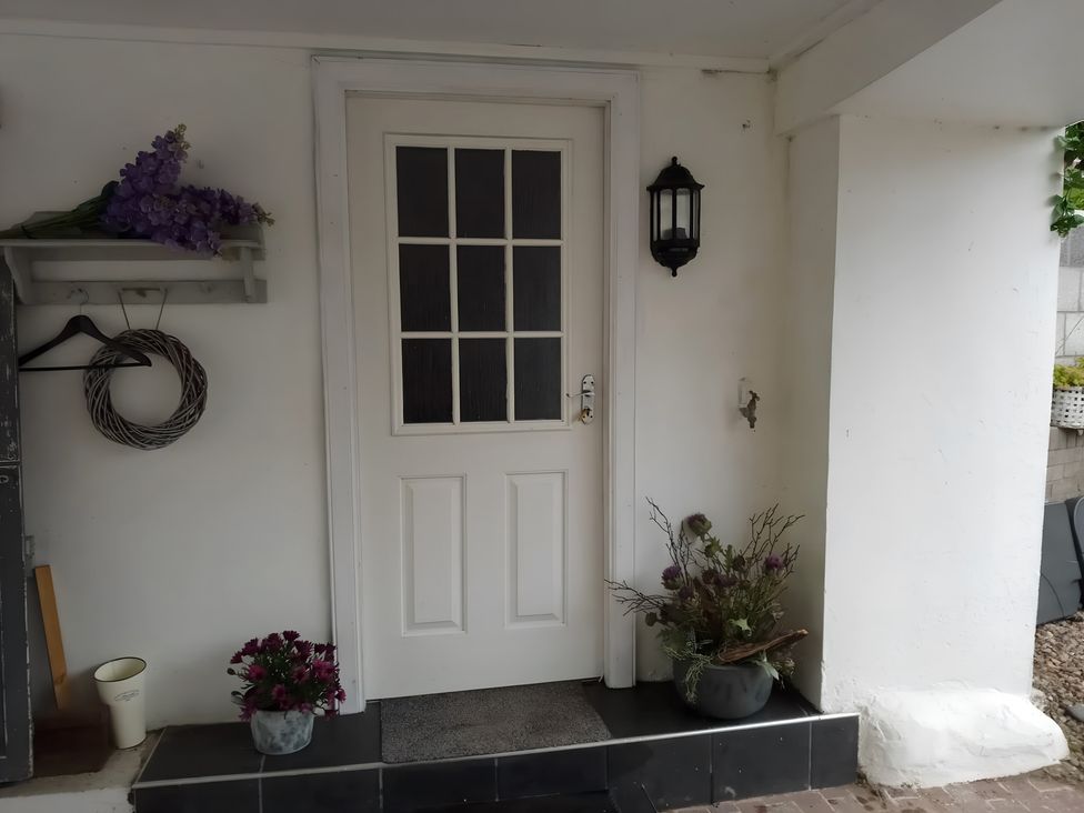 An entrance with a door and flower arrangements at 14 Largo Road in Leven