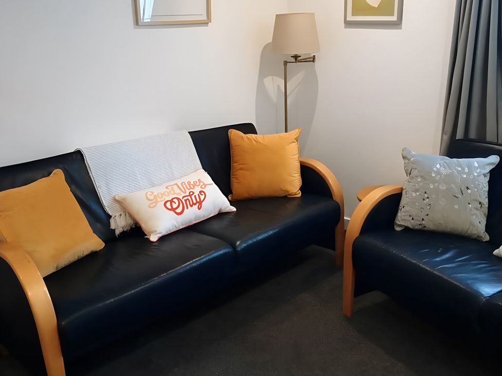 A living room with a sofa and lamp at 14 Largo Road in Leven