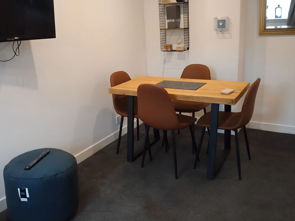 A dining room with a table and chairs at 14 Largo Road in Leven