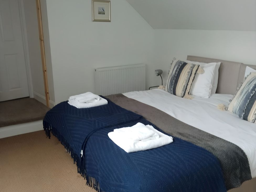A bedroom with a bed and towels at 14 Largo Road Leven