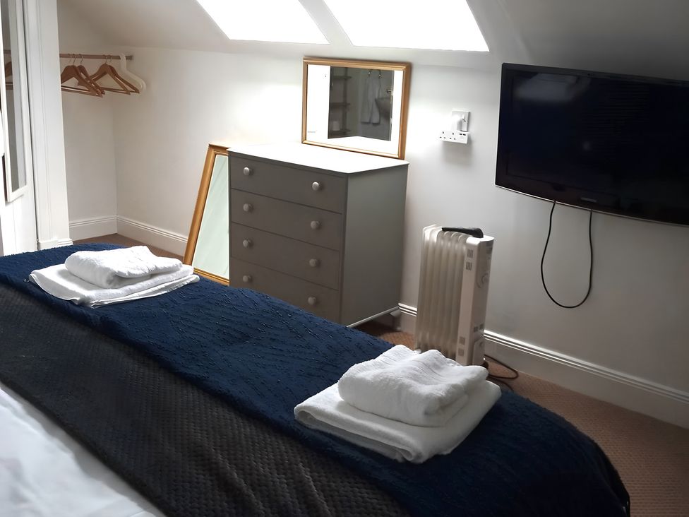 A bedroom with a bed, dresser, mirror and television at 14 Largo Road in Leven