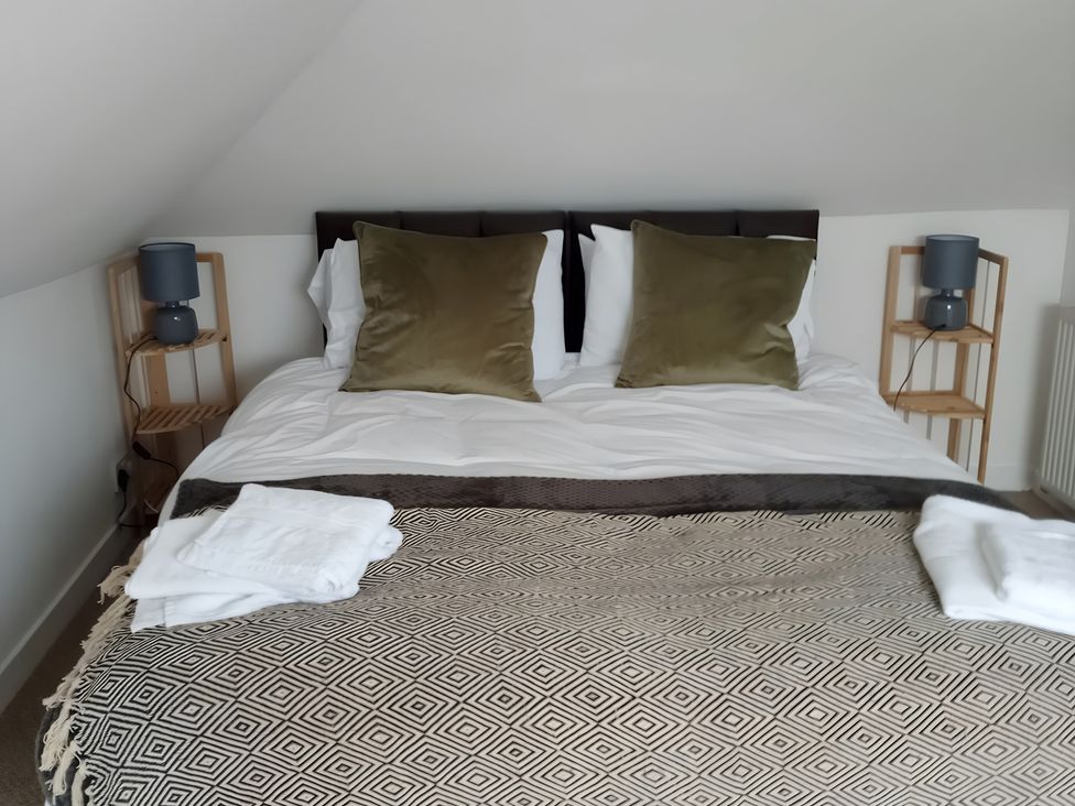 A bedroom with a bed and bedside tables at 14 Largo Road in Leven