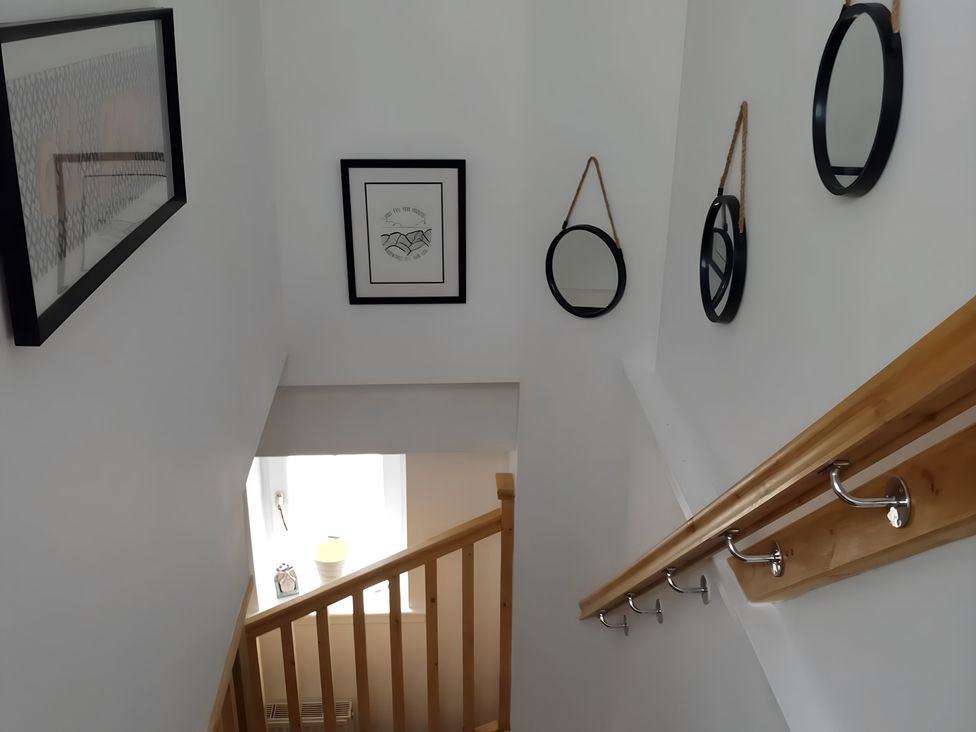 A staircase with mirrors and artwork at 14 Largo Road in Leven