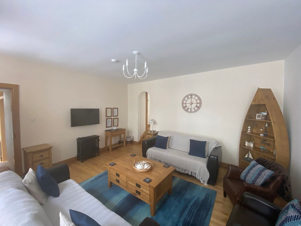 A living room with a coffee table and sofa at Coastal Cottage in Anstruther