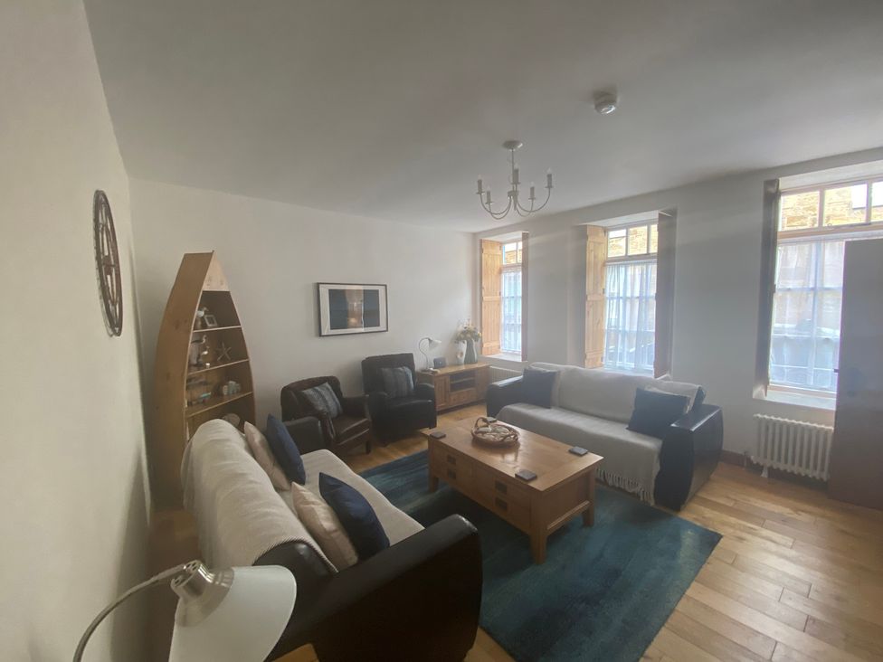 A living room with a sofa and coffee table at Coastal Cottage in Anstruther