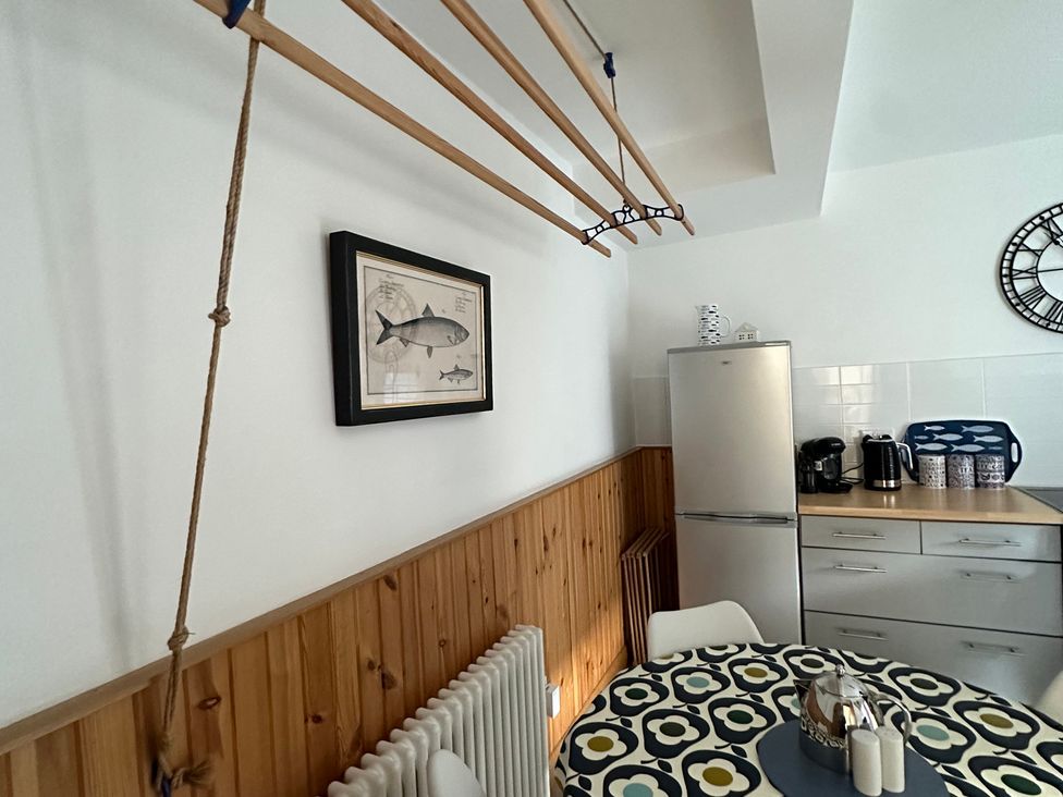 A kitchen with a refrigerator and coffee maker at Coastal Cottage in Anstruther