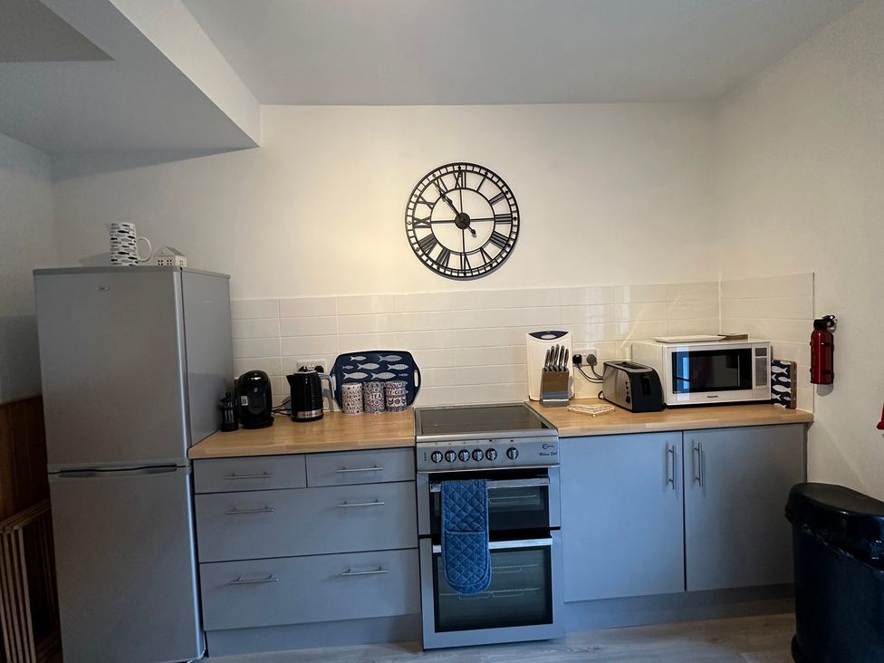 A kitchen with appliances and fixtures at Coastal Cottage in Anstruther