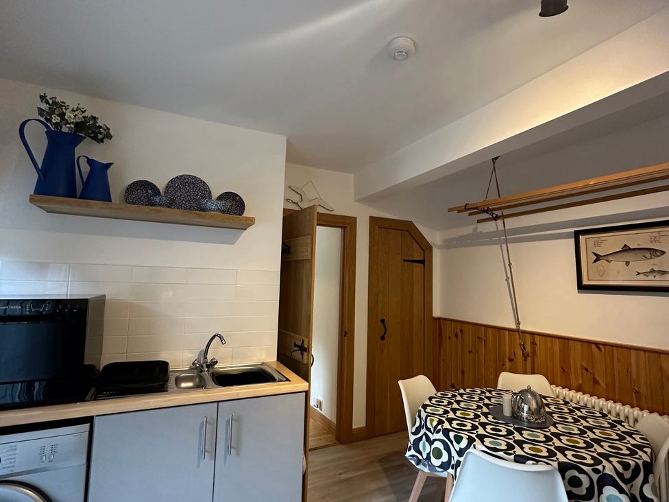A kitchen with a table and chairs at Coastal Cottage in Anstruther