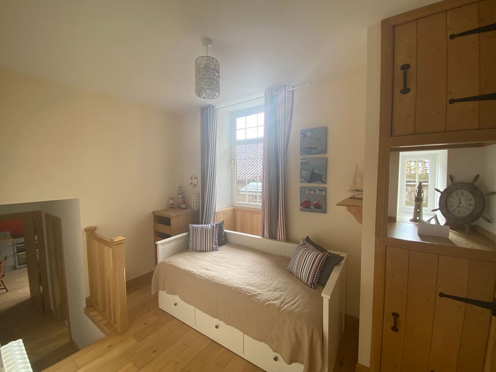 A bedroom with a bed and window at Coastal Cottage Anstruther