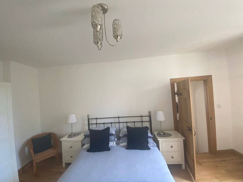A bedroom with a bed and bedside tables at Coastal Cottage in Anstruther