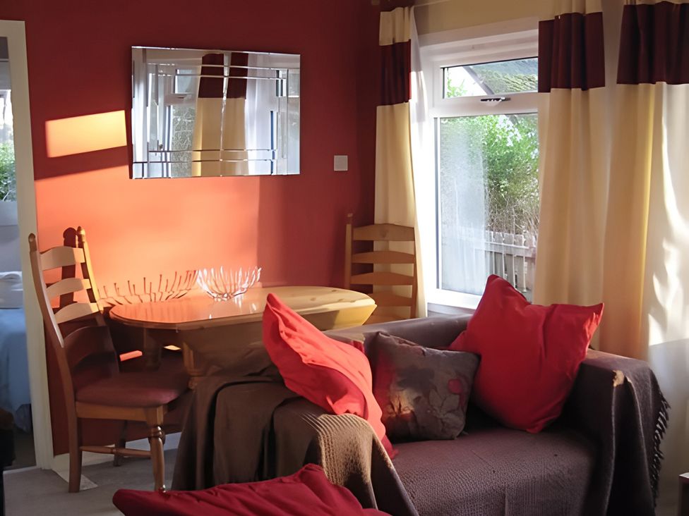 A living room with a table and chairs at Satchwell Chalet Inverness