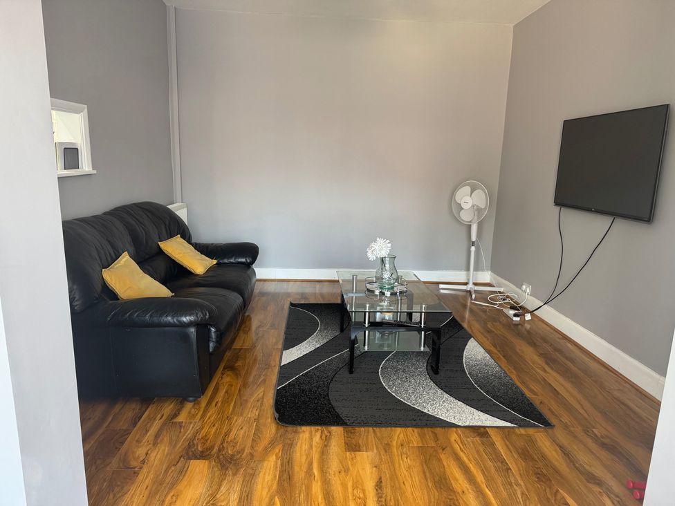 A living room with a sofa and coffee table at Westwick Gardens Retreat in Hounslow
