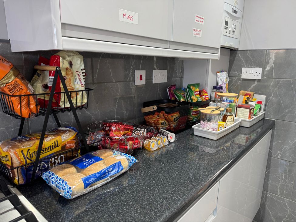 A kitchen counter with food items arranged at Westwick Gardens Retreat in Hounslow