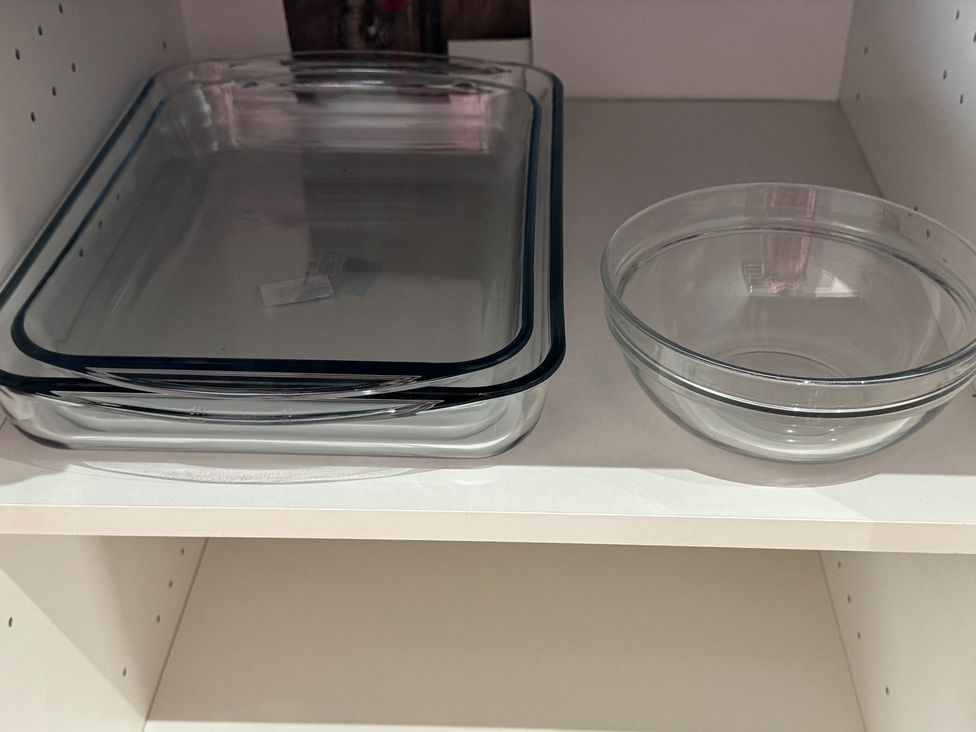 A baking dish and a bowl on a shelf at Westwick Gardens Retreat Hounslow