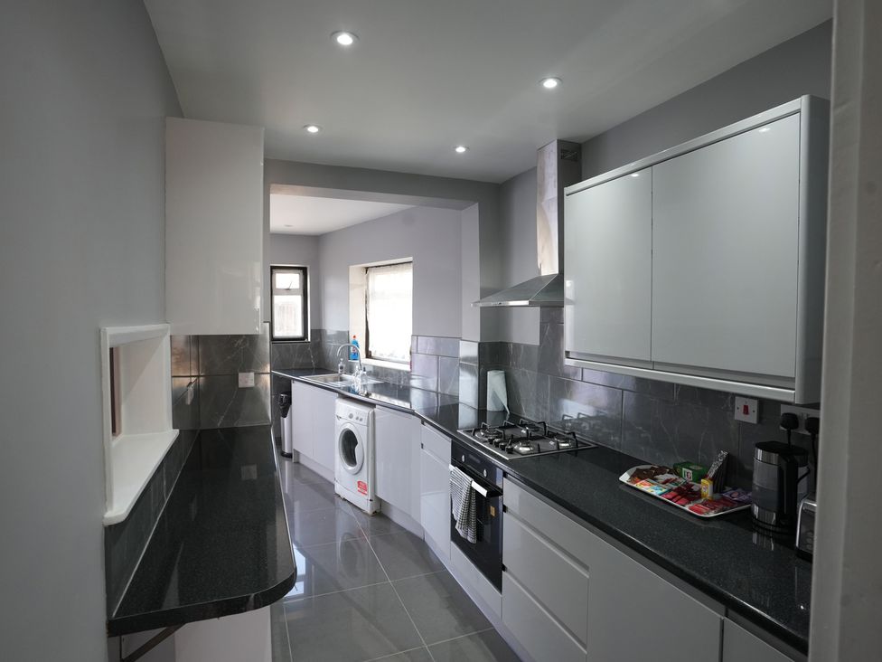 A kitchen with modern appliances at Westwick Gardens Retreat Hounslow