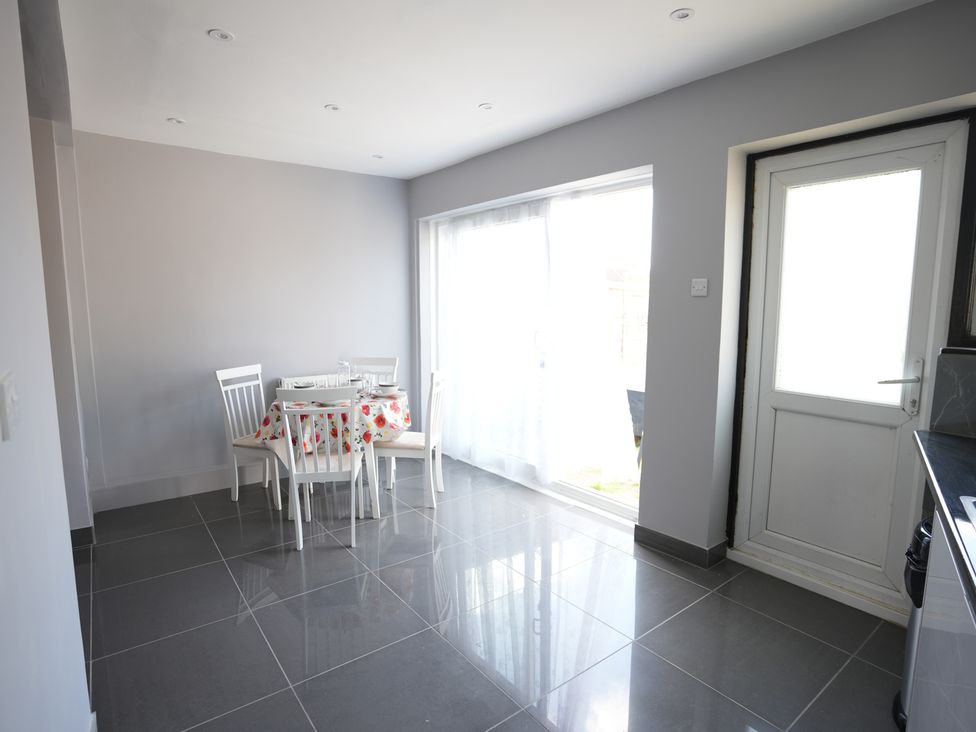 A dining room with a table and chairs at Westwick Gardens Retreat Hounslow