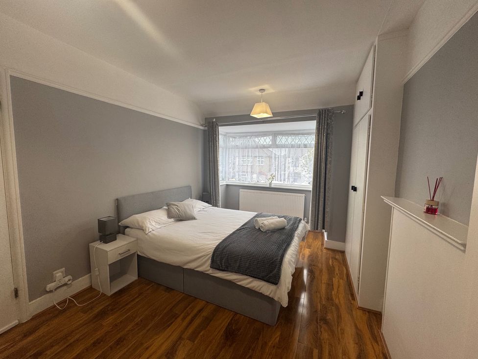 A bedroom with a bed and window at Westwick Gardens Retreat Hounslow