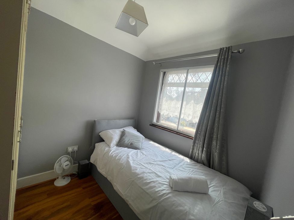 A bedroom with a bed and window at Westwick Gardens Retreat in Hounslow