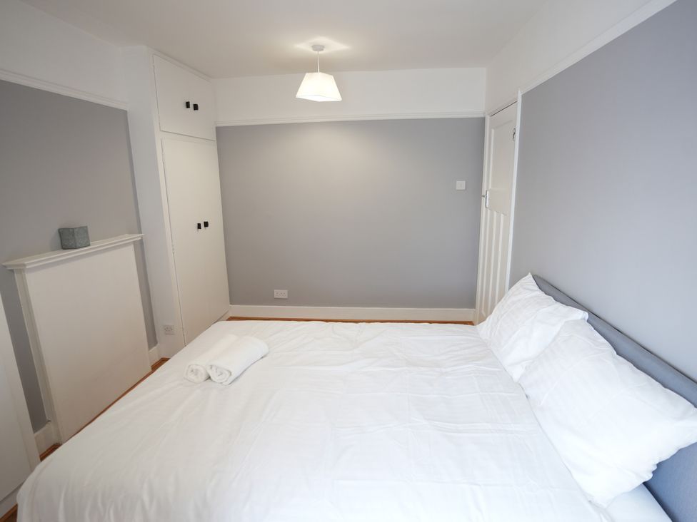 A bedroom with a bed and towels at Westwick Gardens Retreat in Hounslow