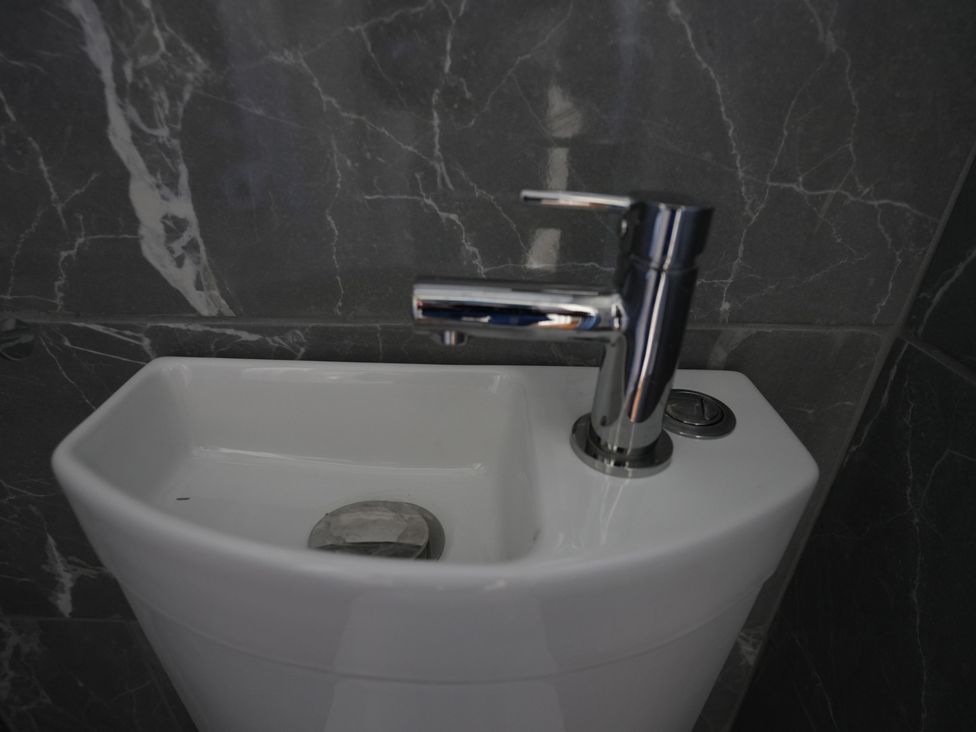 A sink with a tap in a bathroom at Westwick Gardens Retreat Hounslow
