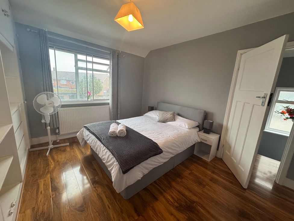 A bedroom with a bed and window at Westwick Gardens Retreat in Hounslow