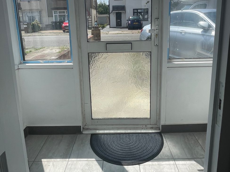 An entrance with a door and window at Westwick Gardens Retreat in Hounslow