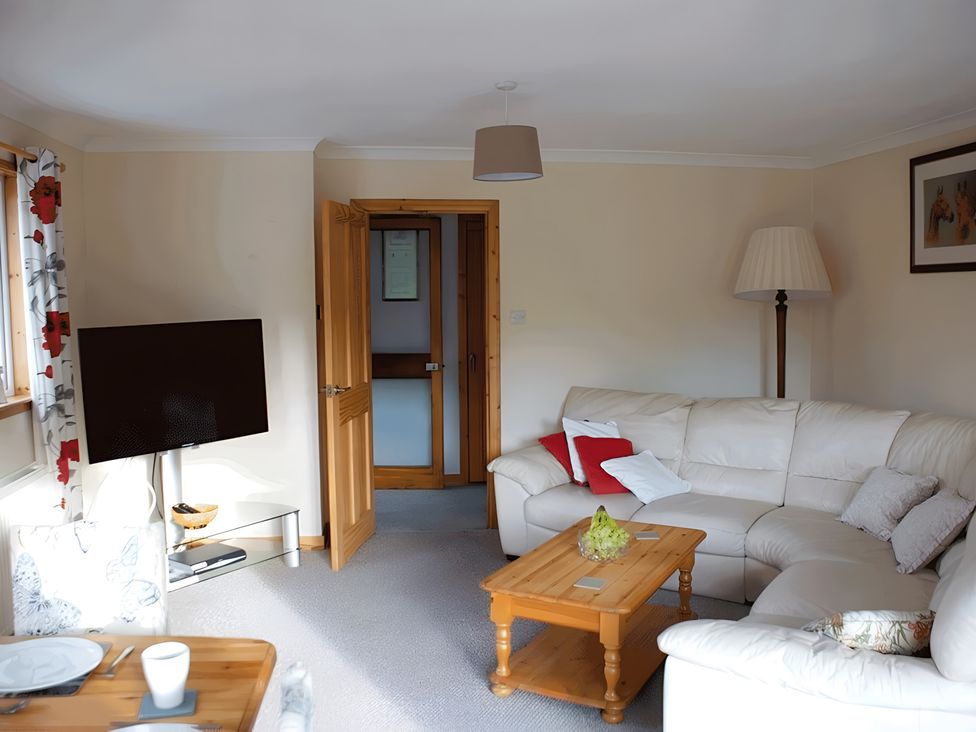 A living room with a sofa and television at Culnacraig in Stranraer
