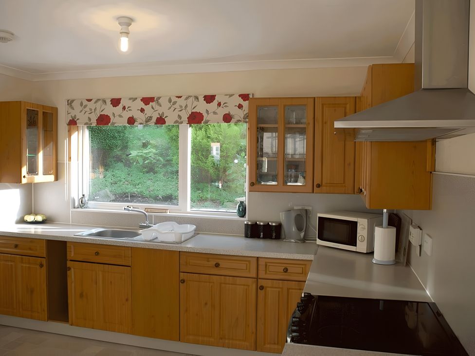 A kitchen with cabinets and appliances at Culnacraig in Stranraer