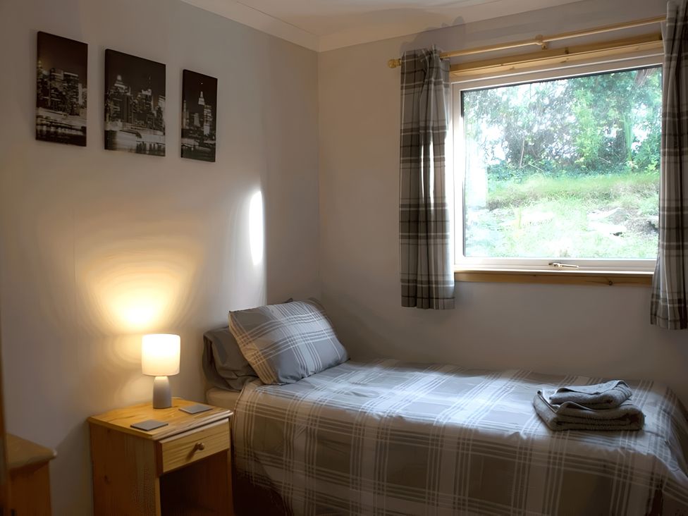 A bedroom with a single bed and a window at Culnacraig in Stranraer