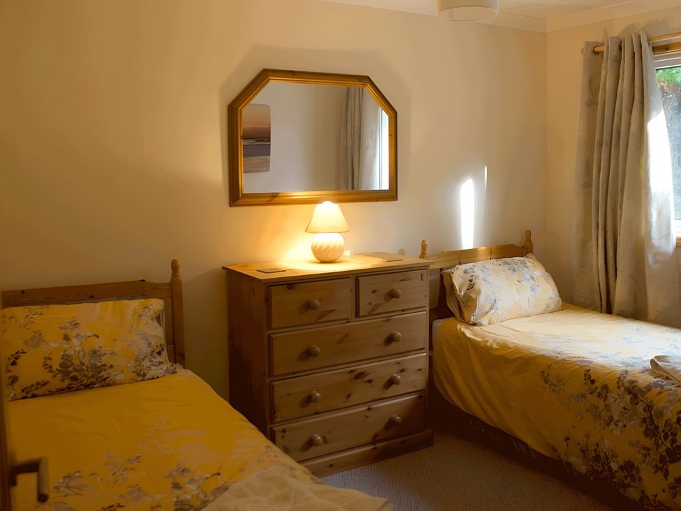 A bedroom with two beds and a dresser at Culnacraig Stranraer