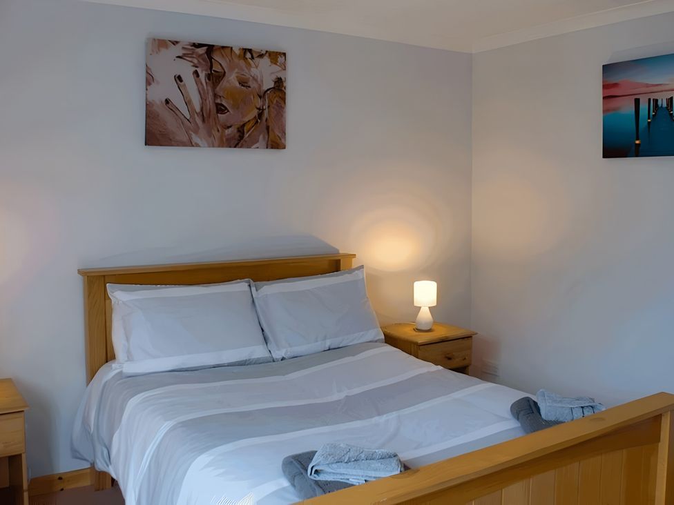 A bedroom with a bed and bedside table at Culnacraig in Stranraer